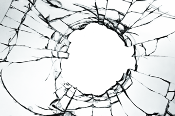 Cracked broken glass on a white background. Damaged window texture with a hole