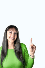 Young woman pointing up over white background. Copy space in left side