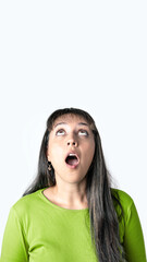 Surprised young woman looking up with mouth open on white background