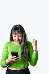 Portrait of a happy young woman using mobile phone while celebrating success