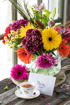 Mother's Day arrangement with tea, card and bouquet of beautiful flowers.