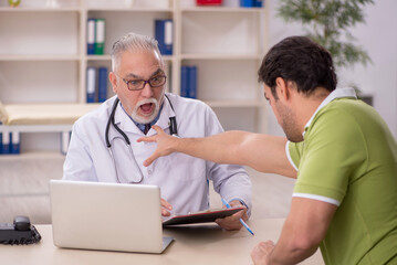 Young male patient visiting old male doctor