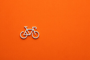 white bicycle icon on orange color background - Transportation concept, graphic resource for design