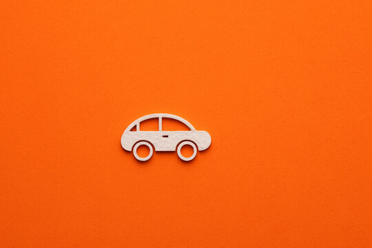 White car on orange colored background - car symbol for web site design or logo © Luis Echeverri Urrea