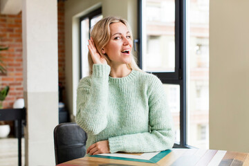 young pretty woman looking happy, listening, trying to hear a secret conversation or gossip,...