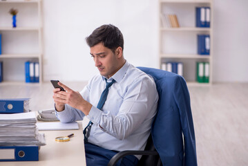 Young male employee working in the office