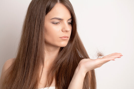 Young woman with comb worried about hair loss