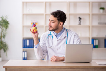 Young male doctor cardiologist working in the clinic