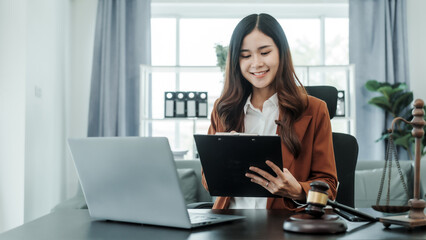 Online consulting with laptop in office of asian thai japanese chinese female exclusive lawyer legal advisor, legislation, saleswoman, legal contract documents