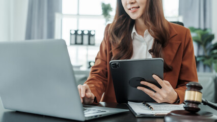 Using tablet pc, Online consulting with laptop in office of asian thai japanese chinese female exclusive lawyer legal advisor, legislation, saleswoman, legal contract documents