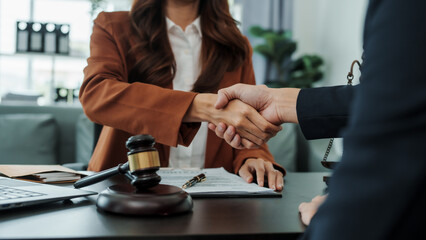 Shaking hands, Bribery of female asia japanese chinese lawyer people earn dollars after winning a lawsuit. extorting money from clients in legal cases