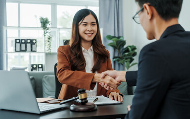 Shaking hands, Bribery of female asia japanese chinese lawyer people earn dollars after winning a lawsuit. extorting money from clients in legal cases