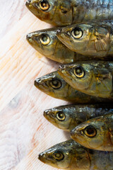 Seafood background, salted and pressed sardines on wooden table