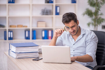 Young male employee working in the office