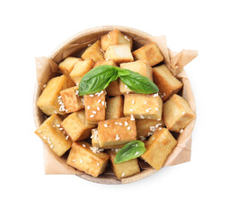 Bowl with delicious fried tofu, basil and sesame seeds on white background, top view