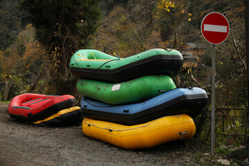 Inflatable rubber fishing boats and trees outdoors