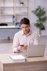 Young male employee working in the office