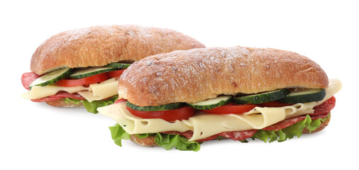 Delicious sandwiches with fresh vegetables, cheese and salami isolated on white