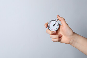 Woman holding vintage timer on white background, closeup. Space for text