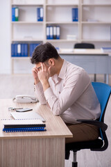 Young male employee working in the office