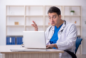 Young male doctor in telemedicine concept