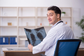 Young male doctor radiologist sitting in the clinic