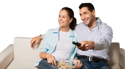 Young couple watching tv siting on a sofa