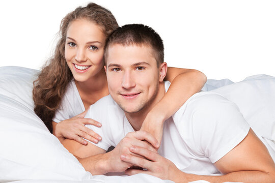 Young Couple In Bed Isolated On White Background