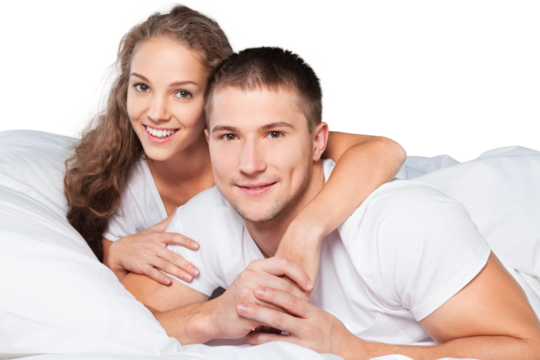 Young couple in bed isolated on white background