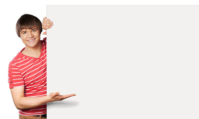 Close-up of a young man standing by white blank card