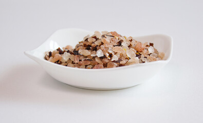 himalaya pink salt with red pepper on white plate.