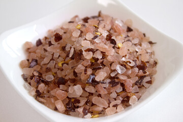 himalaya pink salt with red pepper on white plate.