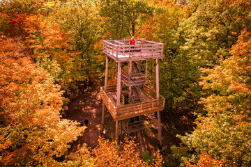 Woman in a red jacket on the Mountain Tower, fall colors