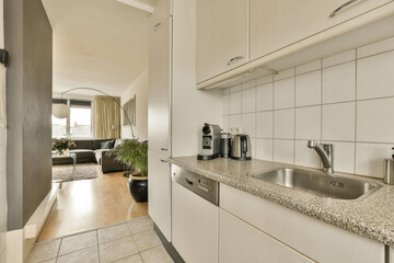a kitchen area with white cabinets and counter space for the sink, dishwasher and coffee maker on the right side