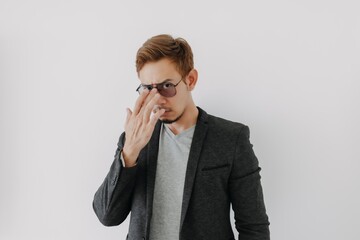 Serious and aggressive Asian man in black suit isolated on white.