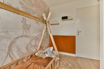 an animal is on the wall next to a wooden cribt in a child's room with orange walls