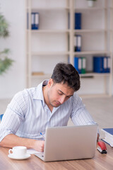 Young male employee working in the office