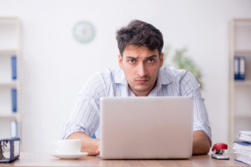 Young male employee working in the office