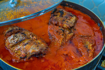 Saucepan of Nigerian pepper tomato sauce fish stew