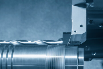 Close up scene the CNC lathe machine thread cutting at the end of metal shaft  parts. - obrazy, fototapety, plakaty