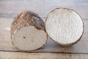 A tuber of yam cut in two ready for cooking