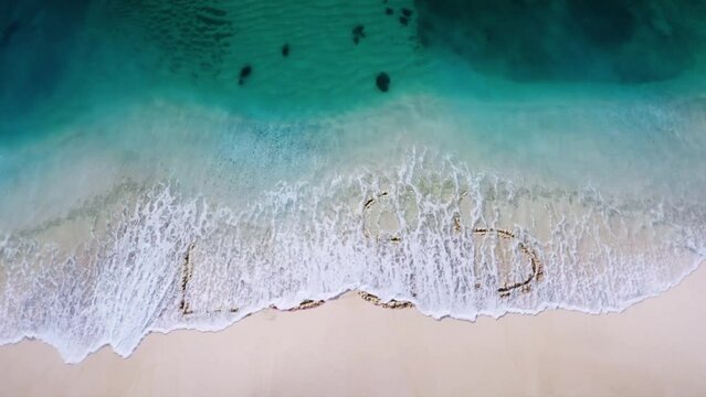 loss_profit letter  written on the beach sand and erased with a wave,and reveals  a new letter  concept video 