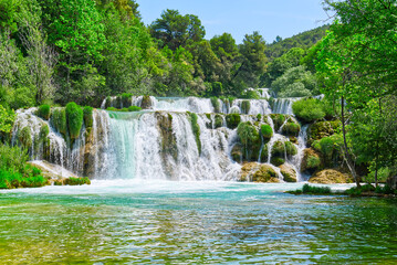 Beautiful Waterfall background in sunny summer day. Beautiful Waterfall In Krka National Park - Croatia, Europe. Krka river waterfalls in the Krka National Park