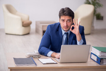 Young male employee working in the office