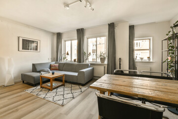 a living room with a couch, coffee table, and tv in the corner of the room is very clean