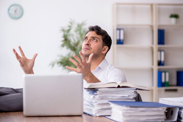 Young male employee working in the office