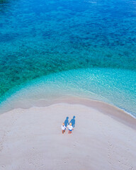 couple of men and women on the beach of Ko Lipe Island Thailand
