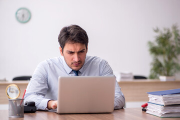 Young male employee working in the office