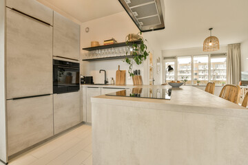 a kitchen and dining area in a house with an open door leading to the living room on the other side