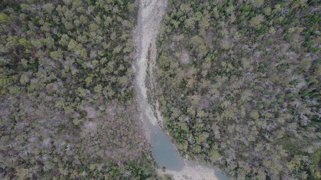 Apsley Gorge Waterhole And Exposed Riverbed Surrounded By Dense Forest In Douglas-Apsley, Tasmania. aerial tilt-up
